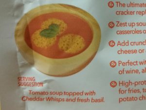 Serving suggestion for tomato soup topped with Cheddar Whisps