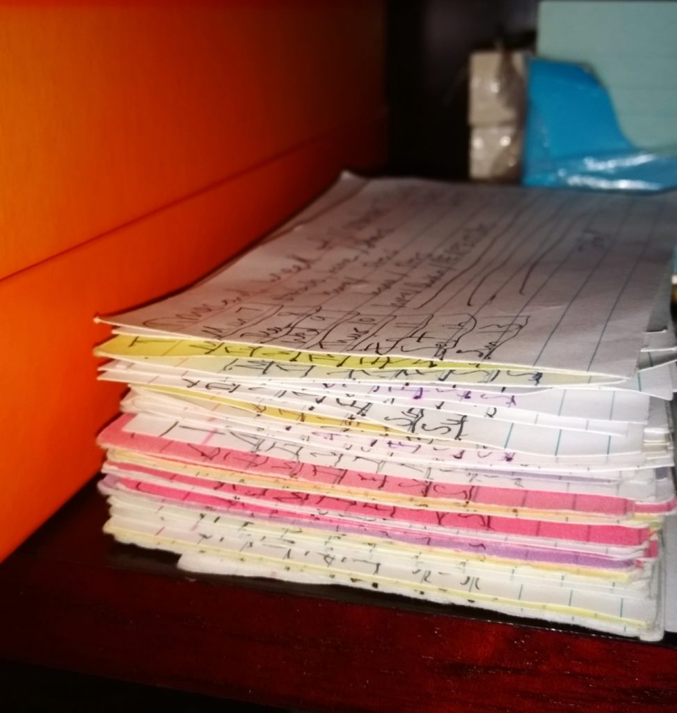 A stack of white and colored index cards.