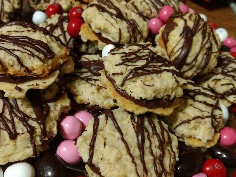 Chocolate ganache sandwich cookies with red and pink M&Ms